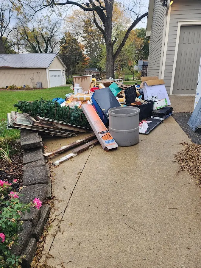 Dumpster being loaded with debris for Estate Cleanout Dumpster Rental in Surrey